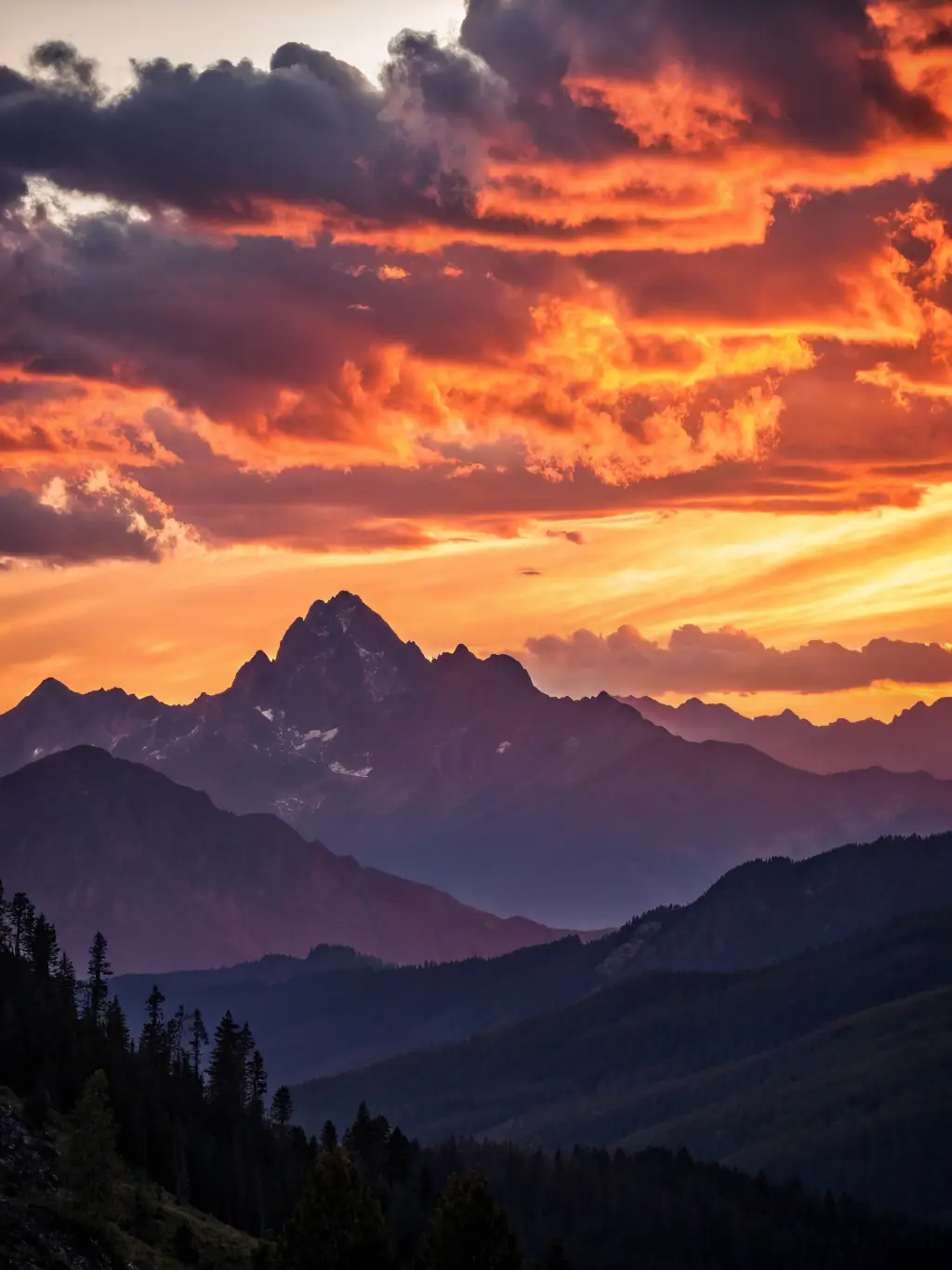 A landscape photographer capturing a breathtaking sunset over a mountain range, using a wide-angle lens to capture the vastness of the scene.